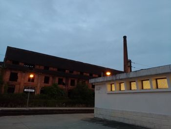 Low angle view of illuminated building against sky at dusk