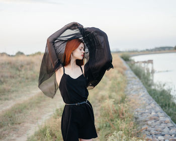 Full length of woman standing on field