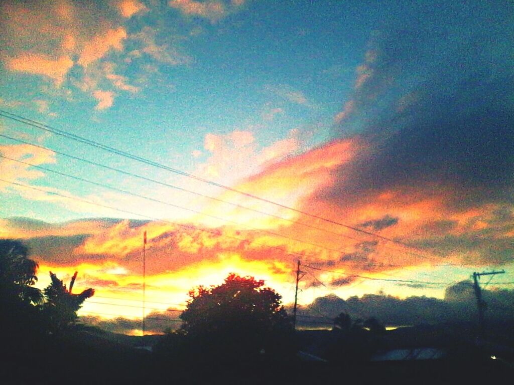 sunset, silhouette, sky, power line, tree, orange color, cloud - sky, beauty in nature, scenics, tranquility, electricity pylon, tranquil scene, low angle view, nature, dramatic sky, cloud, cloudy, idyllic, cable, outdoors