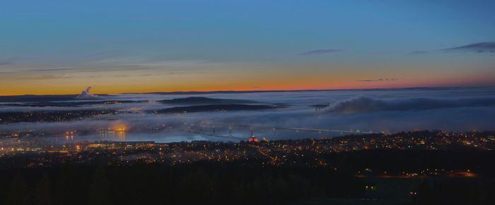 Aerial view of city against sky at sunset