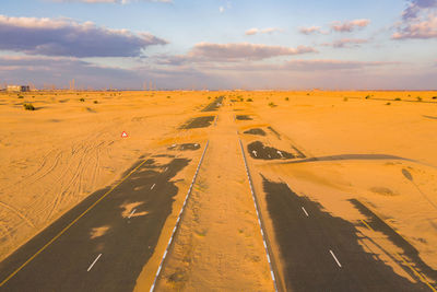 Scenic view of road on desert against sky