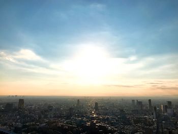 Aerial view of cityscape against sky during sunset