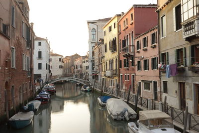 Boats in canal with buildings in background