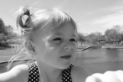 Close-up of girl against sky