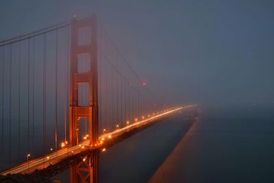 Illuminated bridge at night