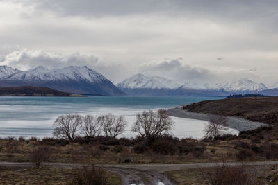 Scenic view of lake and mountains against sky