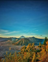 Scenic view of landscape against blue sky