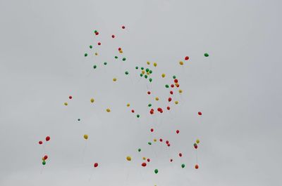 Low angle view of balloons against sky