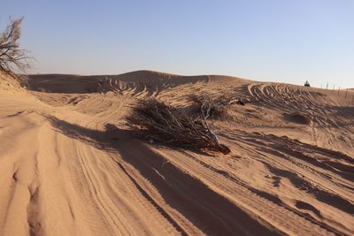 Sand dune in desert against clear sky