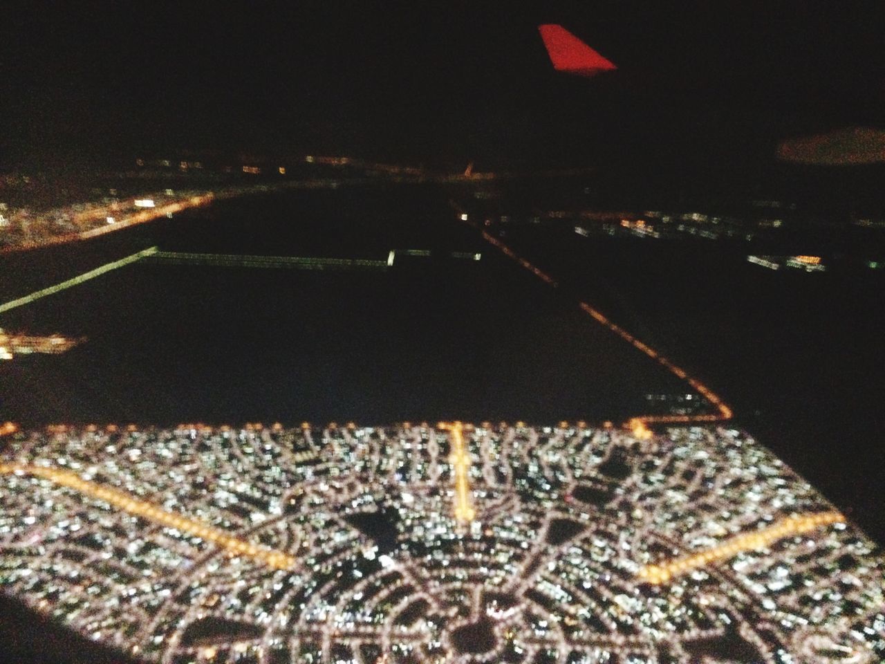 AERIAL VIEW OF ILLUMINATED CITYSCAPE AGAINST SKY