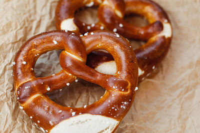 Two traditional soft octoberfest pretzels on brown paper