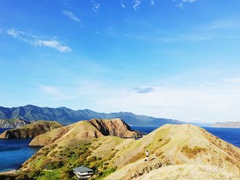 Scenic view of sea and mountains against sky