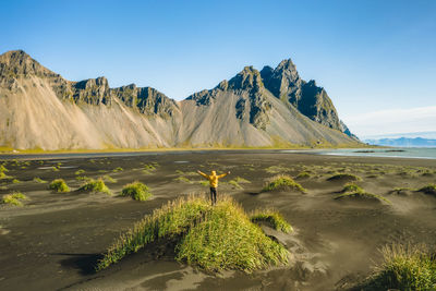 Scenic view of land and mountains against sky