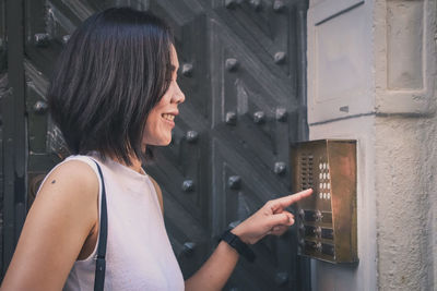 Close-up of smiling woman typing code