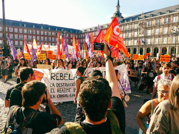 Photojournalist taking a photo of an ecological demonstration in madrid, spain 