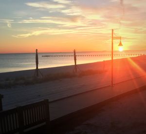 Scenic view of beach against sky during sunset