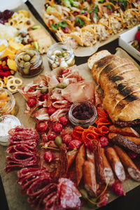 Snacks of smoked sausages, salami and baguette