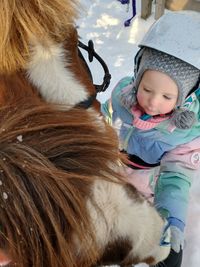 Cute girl in winter with her ponys