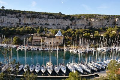 Sailboats in sea against buildings in city