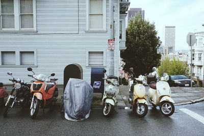 Motorcycle on street against buildings in city