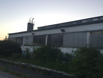 Low angle view of abandoned building against clear sky