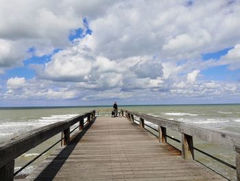 Pier over sea against sky