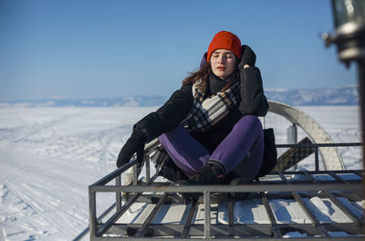 Portrait of smiling woman standing on snow