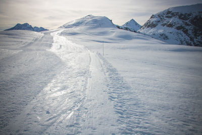 Scenic view of snowcapped mountains against sky
