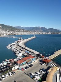 High angle view of city by sea against clear sky