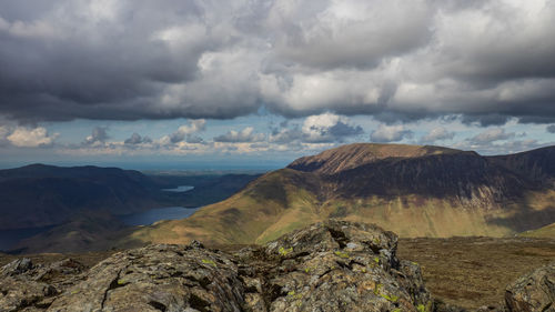 Scenic view of mountains against cloudy sky