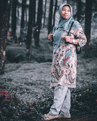 Full length portrait of woman standing on land