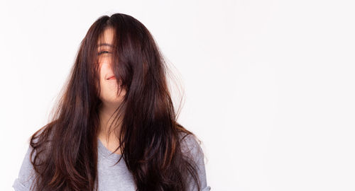 Portrait of a beautiful young woman over white background