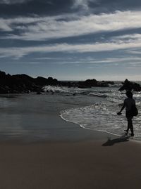 Full length of man on beach against sky