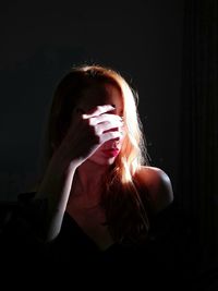 Portrait of young woman in darkroom