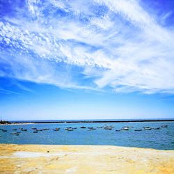 Scenic view of beach against blue sky