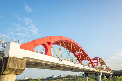 Low angle view of bridge against blue sky