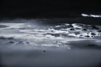 Airplane flying over cloudy sky