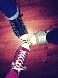 Low section of people standing on hardwood floor