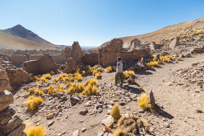 Rear view of woman walking on landscape