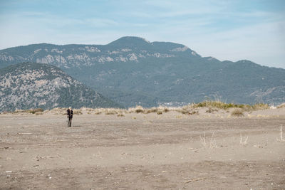 Rear view of person on landscape against sky