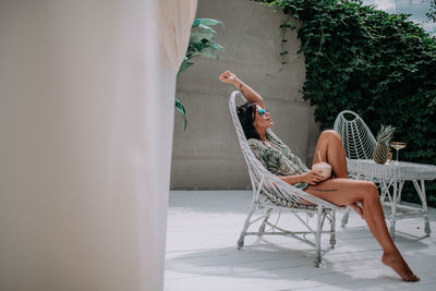 Young woman sitting on chair