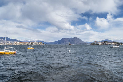 Sailboats in sea against sky