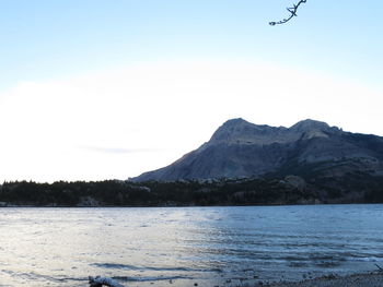 Scenic view of lake and mountains against clear sky