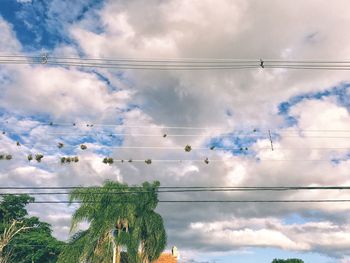 Low angle view of power lines against sky