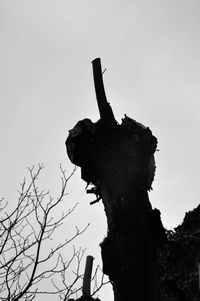 Low angle view of silhouette statue against sky