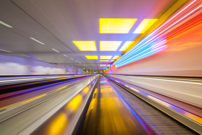 Blurred motion of illuminated moving walkway at airport