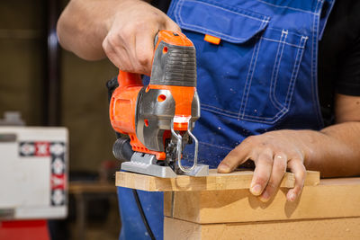 Midsection of man working in workshop