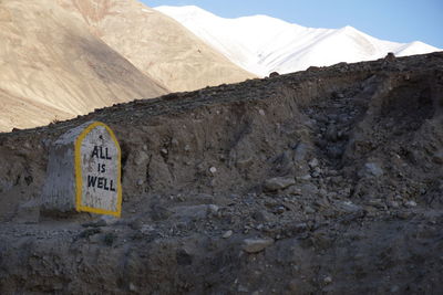 Signboard on barren landscape