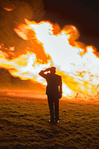 Full length rear view of man standing on field