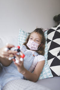 Girl playing with toy at home during quarantine